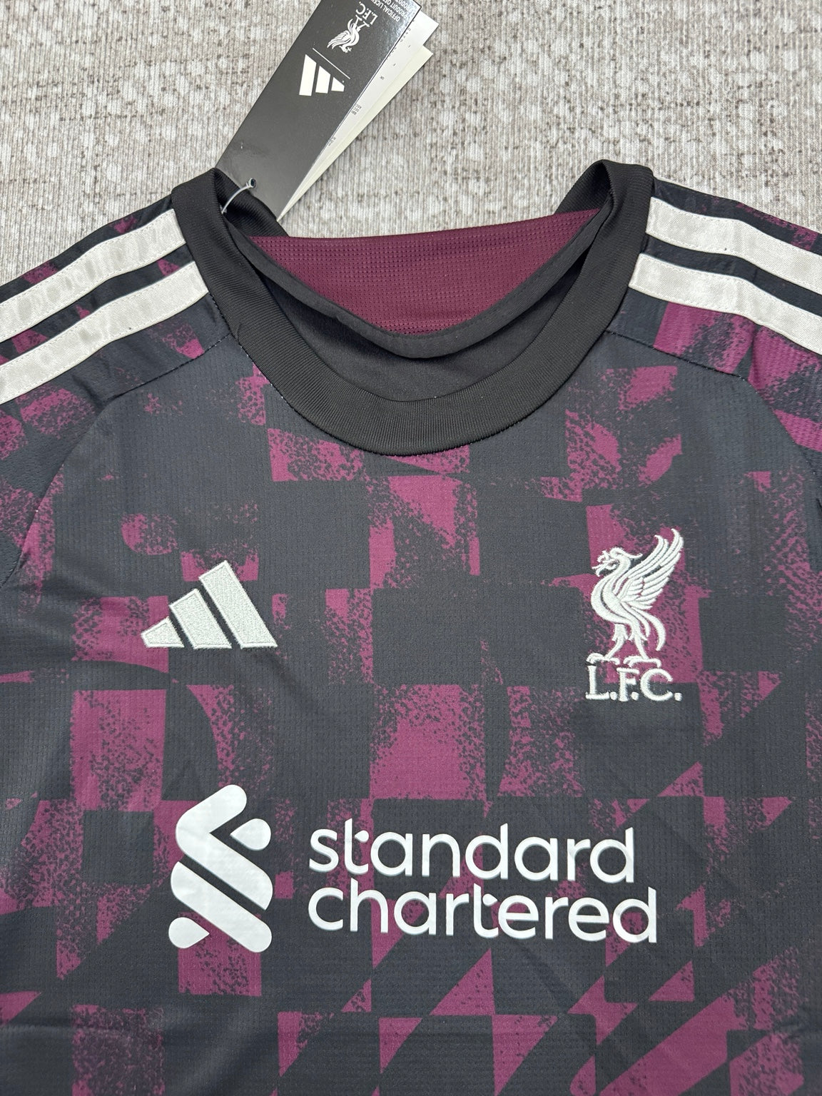 Détail col et écusson maillot Liverpool noir et bordeaux